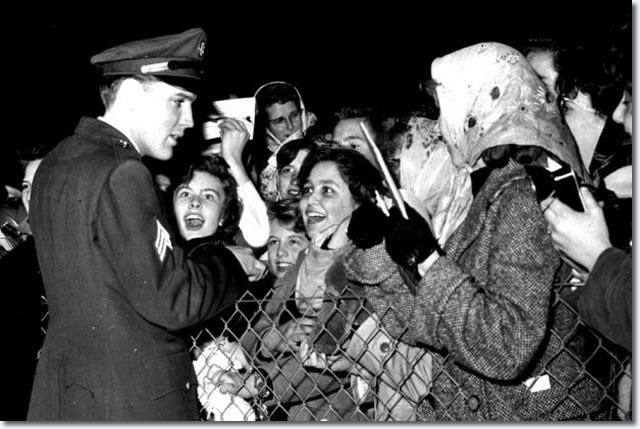 Elvis meets local fans at the perimiter fence and signs autographs