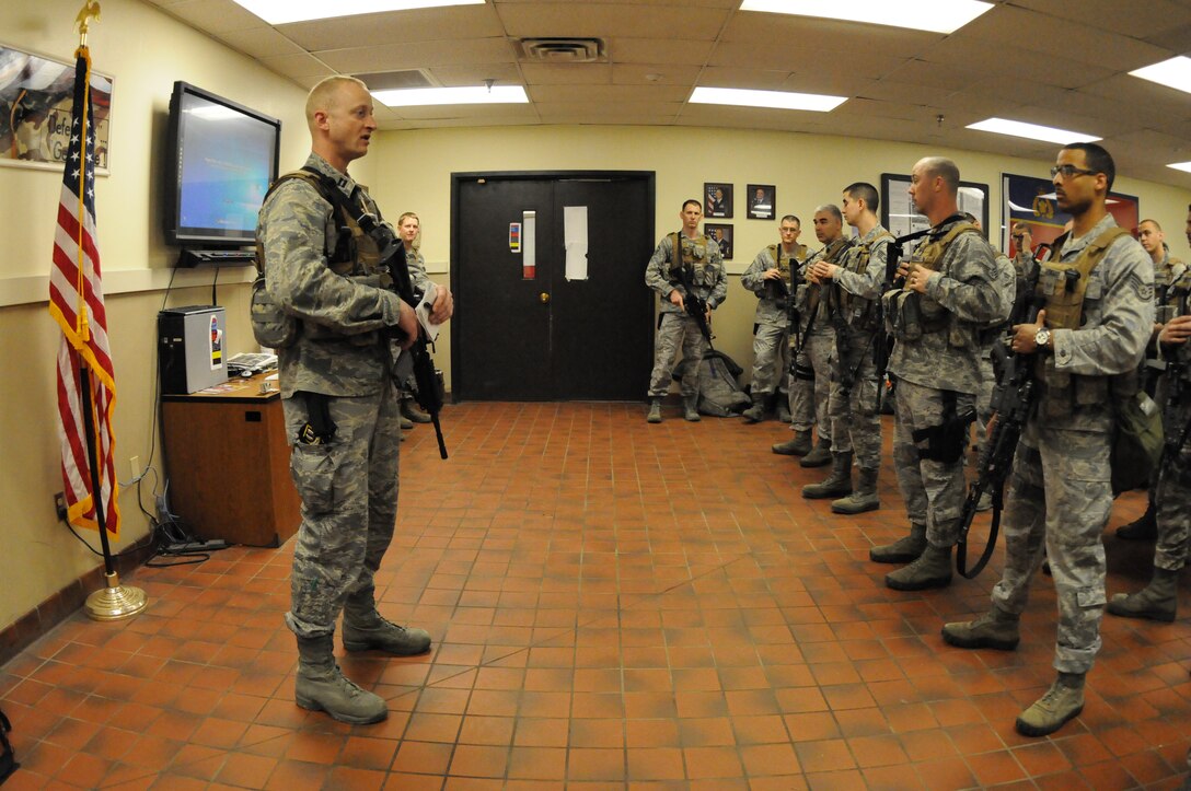 Capt. Gregory Goodman, of the 219th Security Forces Squadron, North Dakota Air National Guard, addresses Minot Air Force Base, N.D., missile field security personnel during a pre-shift briefing May 21, 2013. The formation is integrated with both 219th Security Forces Squadron personnel in the North Dakota Air National Guard and 91st Missile Security Forces Squadron U.S. Air Force active-duty personnel who are preparing to disperse into the Minot Air Force Base missile field complex to provide security for the missile alert facilities. . The missile field complex covers 8,500 square miles in North Dakota, and the Air National Guard members are being integrated with the active-duty personnel in the security mission throughout the complex.