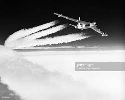 A Boeing B-52 bomber flies above the clouds with contrails flowing... News  Photo - Getty Images