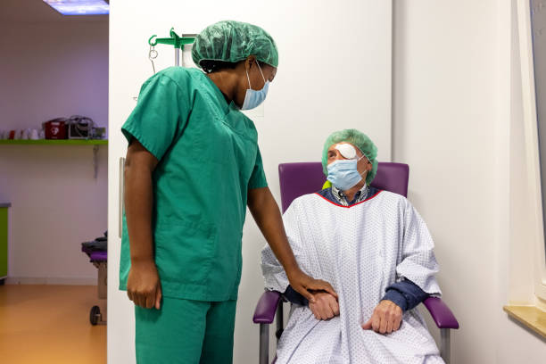 nurse watching senior patient after eye surgery in hospital - cataract surgery stock pictures, royalty-free photos & images